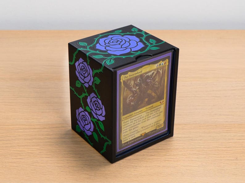 Black deck box with purple roses and green thorned vines